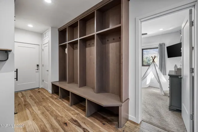 a hallway with wooden floor and furniture