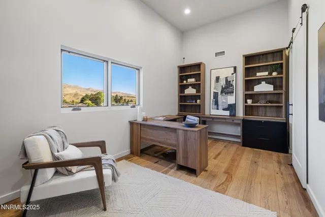 a work room with furniture and a wooden floor
