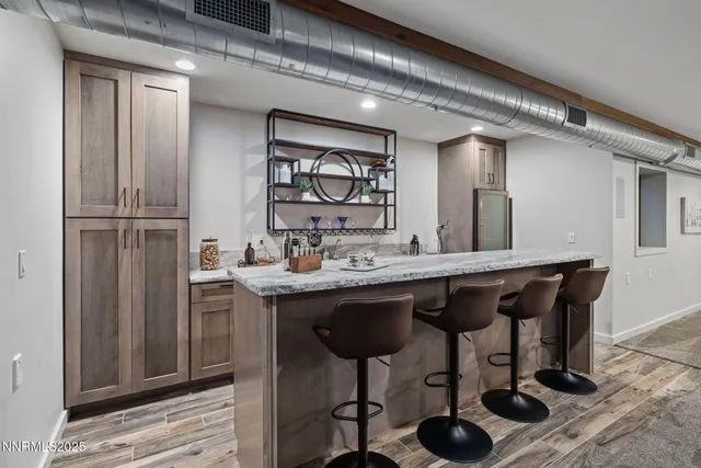 a kitchen with a sink cabinets and dining table chair