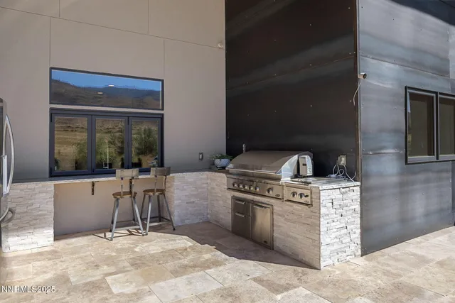 a view of a patio with a table chairs potted plants and a yard