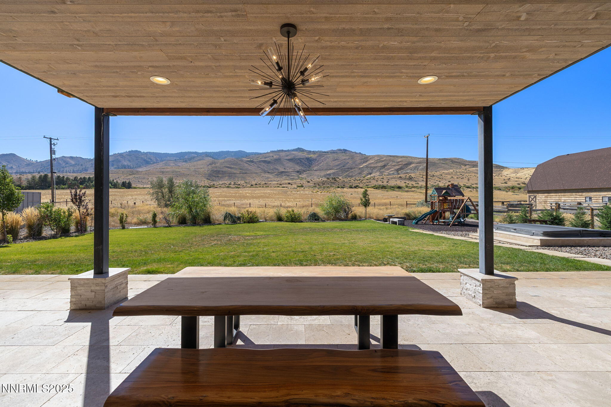 2255 Warrior Lane Reno, NV 89523 - Photo 42 of 52 a view of a patio with a table chairs potted plants and a yard
