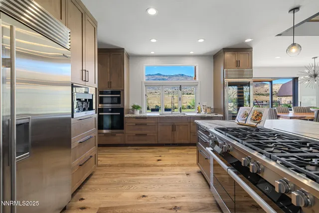 a kitchen with stainless steel appliances kitchen island wooden cabinets and a stove a refrigerator