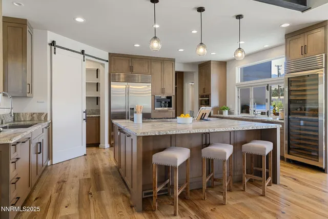 a large kitchen with a table and chairs
