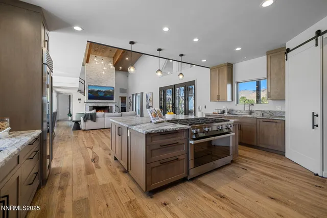 a kitchen with stainless steel appliances granite countertop a stove and a sink