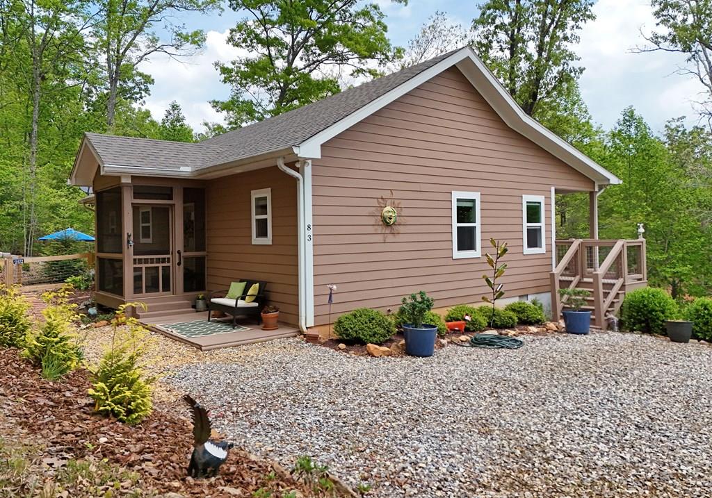 83 Highland Road Blairsville, GA 30512 - Photo 1 of 32 a view of a house with backyard and garden