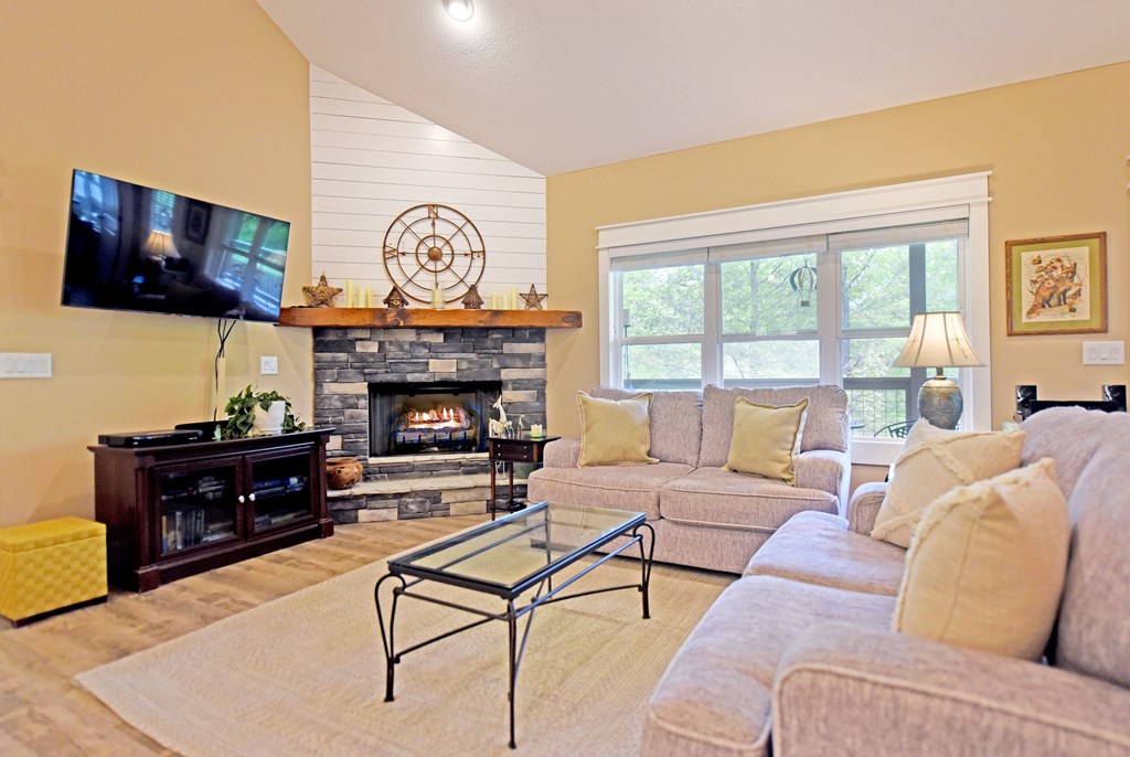 83 Highland Road Blairsville, GA 30512 - Photo 16 of 32 a living room with furniture a flat screen tv and a fireplace