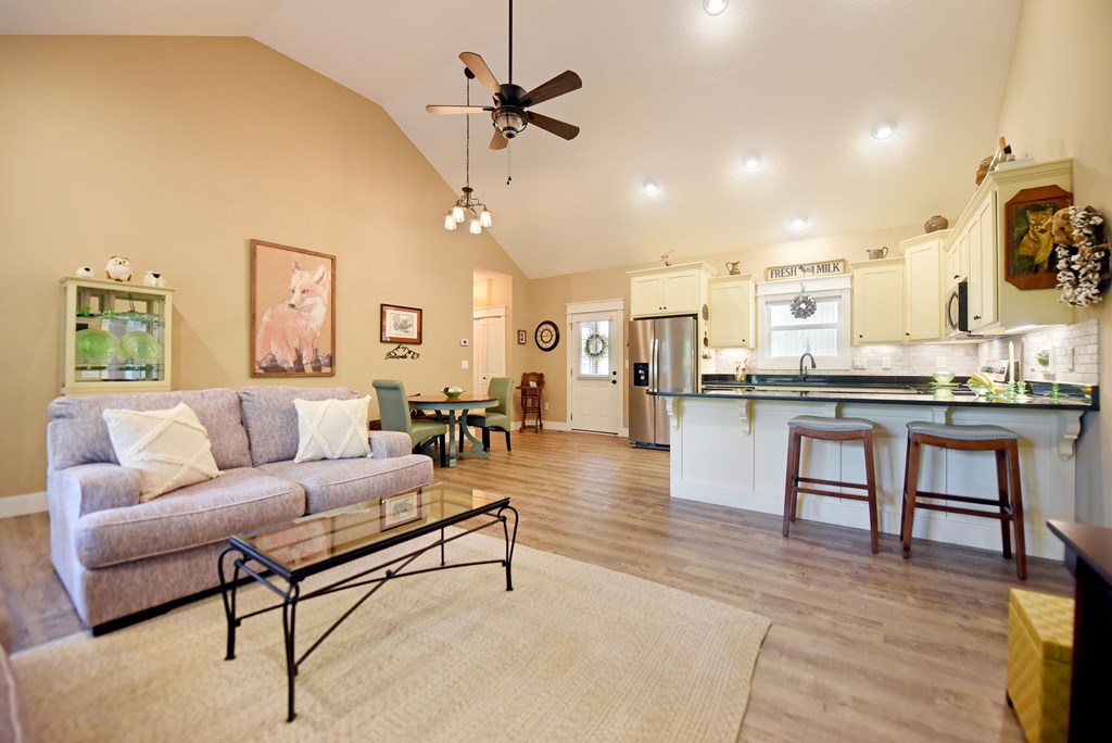 83 Highland Road Blairsville, GA 30512 - Photo 17 of 32 a living room with stainless steel appliances furniture a rug and a kitchen view