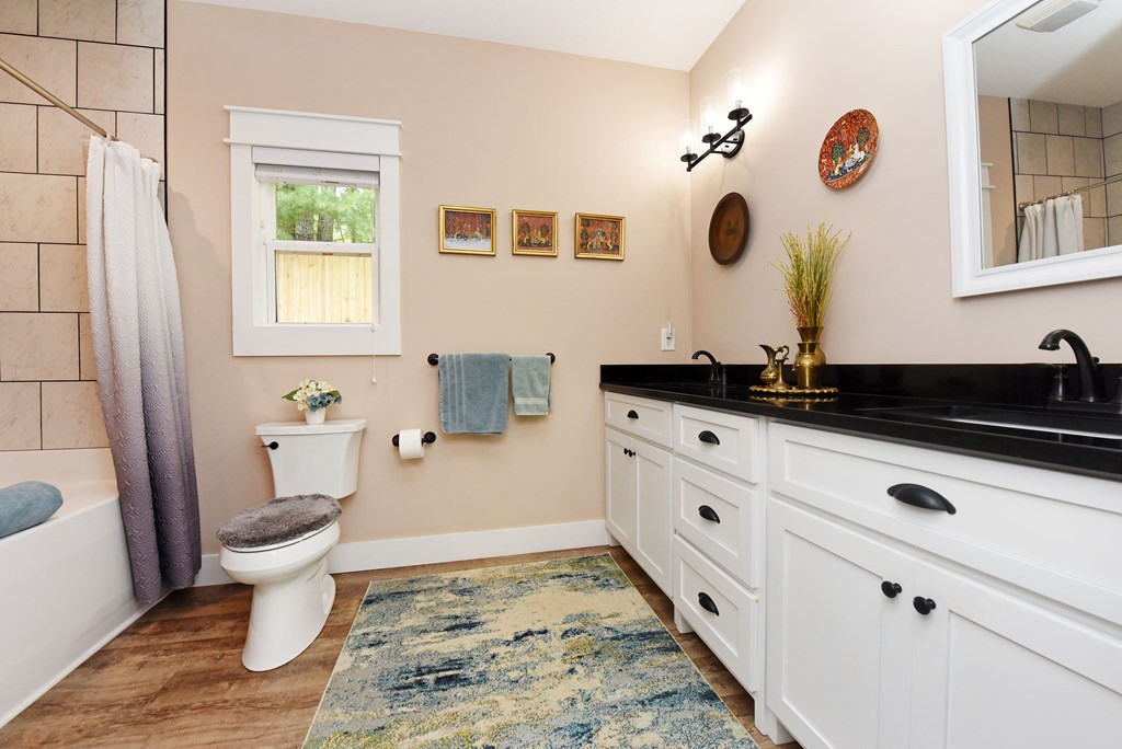 83 Highland Road Blairsville, GA 30512 - Photo 22 of 32 a bathroom with a sink and a mirror