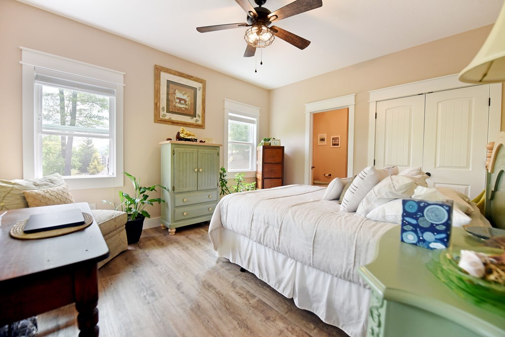 83 Highland Road Blairsville, GA 30512 - Photo 26 of 32 a bedroom with a bed and wooden floor