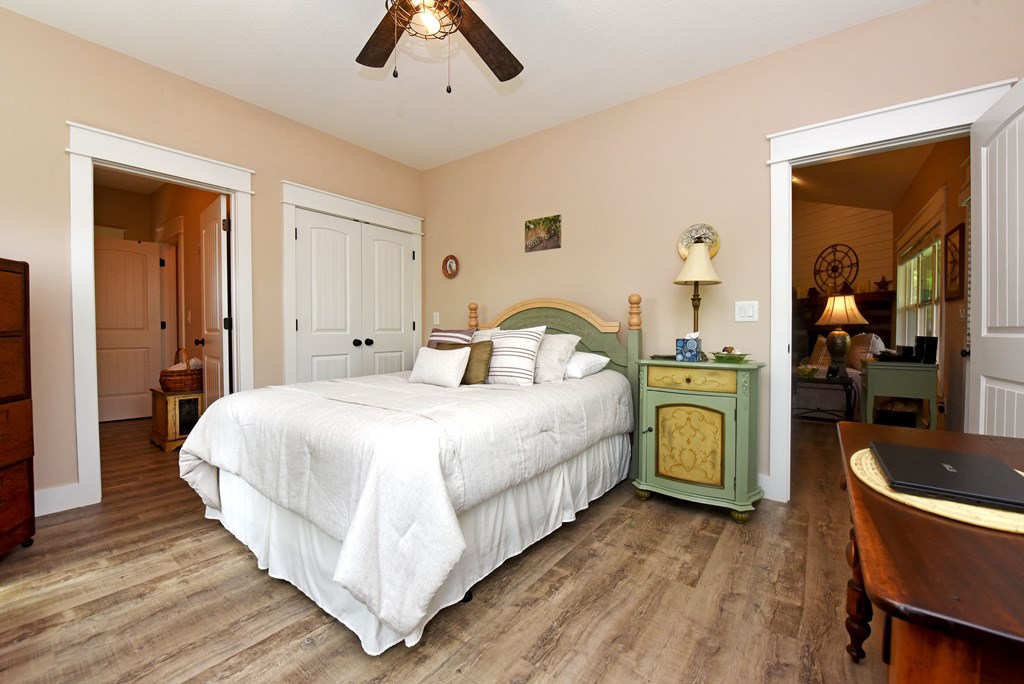 83 Highland Road Blairsville, GA 30512 - Photo 27 of 32 a bedroom with a bed and wooden floor