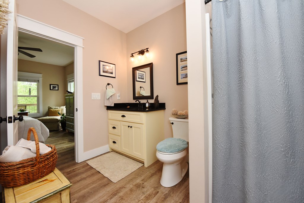 83 Highland Road Blairsville, GA 30512 - Photo 28 of 32 a spacious bathroom with a toilet a sink and a mirror