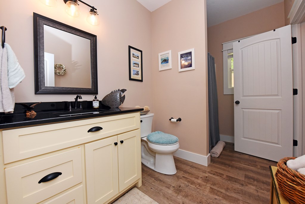 83 Highland Road Blairsville, GA 30512 - Photo 29 of 32 a bathroom with a toilet a sink and mirror