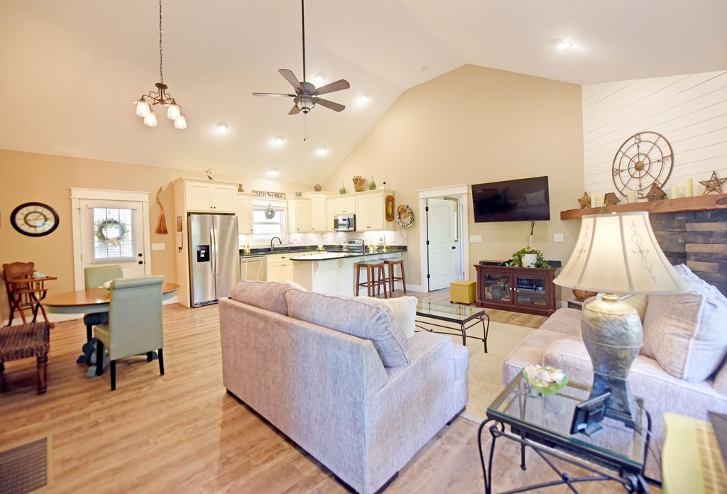 83 Highland Road Blairsville, GA 30512 - Photo 3 of 32 a living room with furniture a flat screen tv and kitchen view