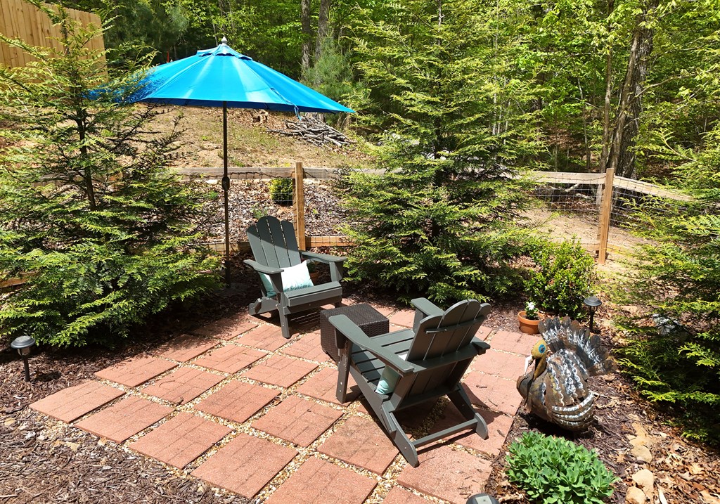 83 Highland Road Blairsville, GA 30512 - Photo 9 of 32 a garden view with a seating space