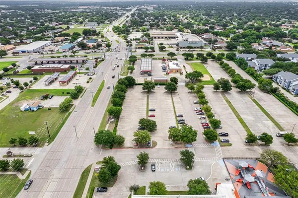 an aerial view of residential houses with outdoor space and parking