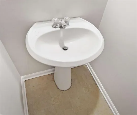 a white toilet sitting next to a white tub