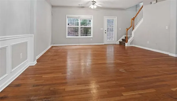 wooden floor in an empty room with a window
