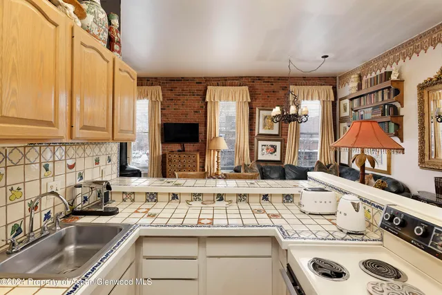 a kitchen with stainless steel appliances a sink stove and cabinets