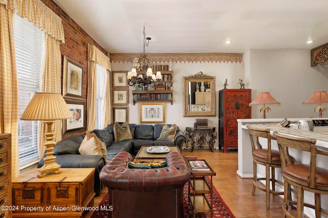 a living room with furniture and a chandelier