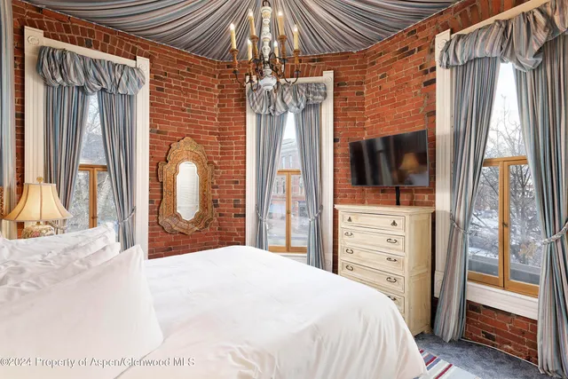 a bedroom with a bed and a flat tv screen