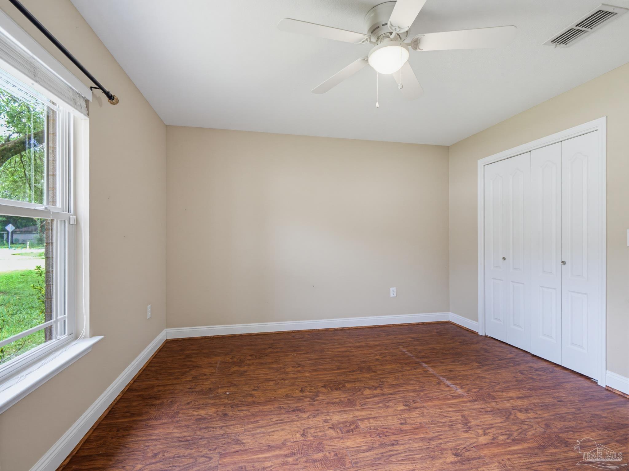 5567 Jones Street Milton, FL 32570 - Photo 34 of 48 wooden floor in an empty room with a window