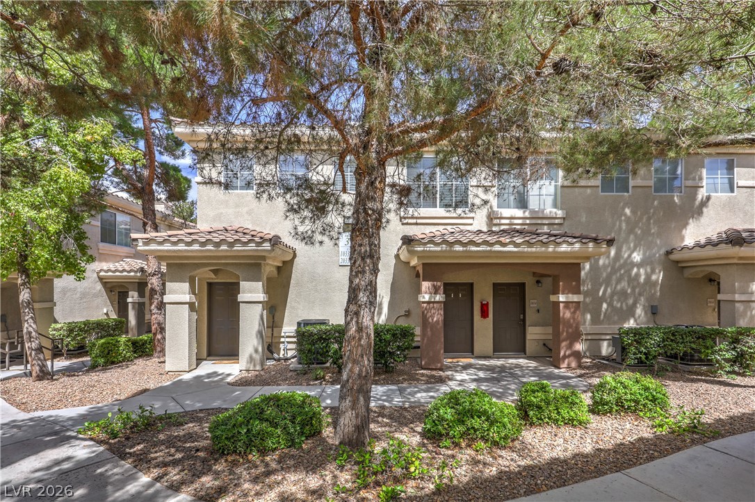 Welcome to a residential complex featuring multiple units with traditional tile roofing and well-maintained landscaping.