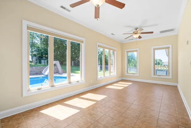 a spacious bedroom with a bed and a chandelier