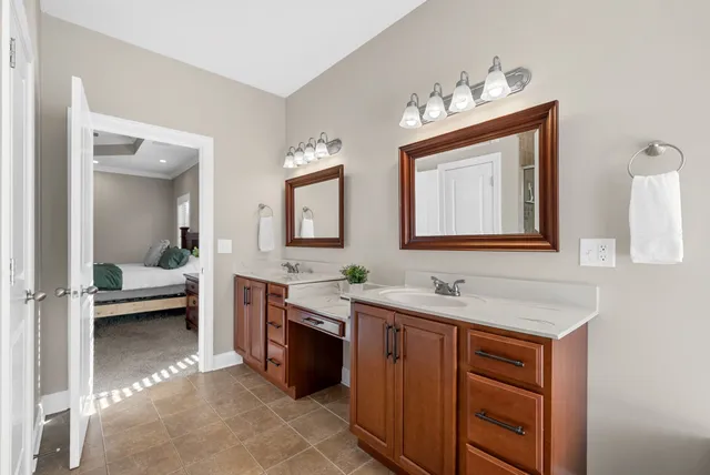 an empty room with chandelier fan and windows