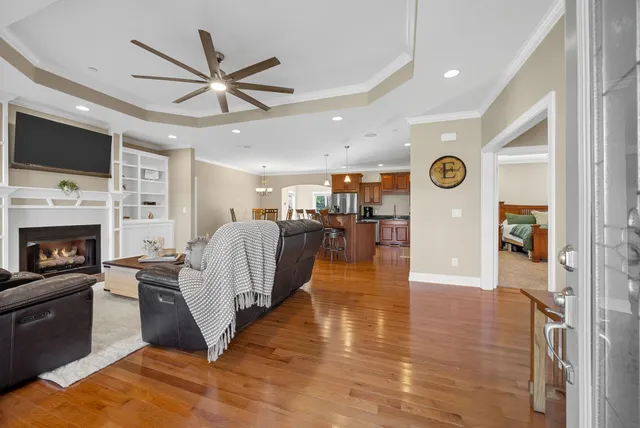 a living room with furniture and a view of kitchen