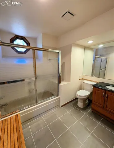 a bathroom with a toilet sink and shower