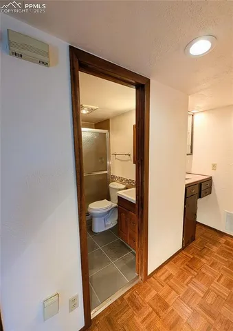 a view of a room with wooden floor and chair