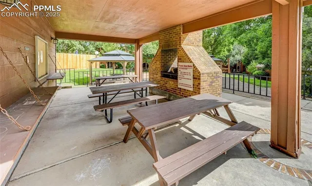 a view of a house with a yard and large trees