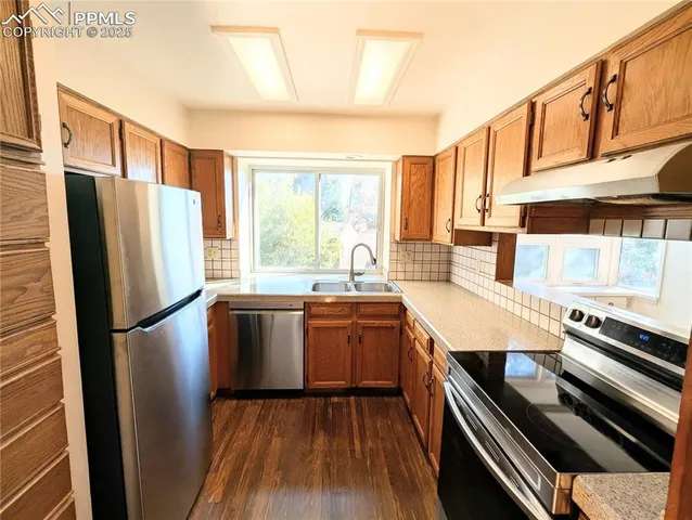 a kitchen with a refrigerator and a stove
