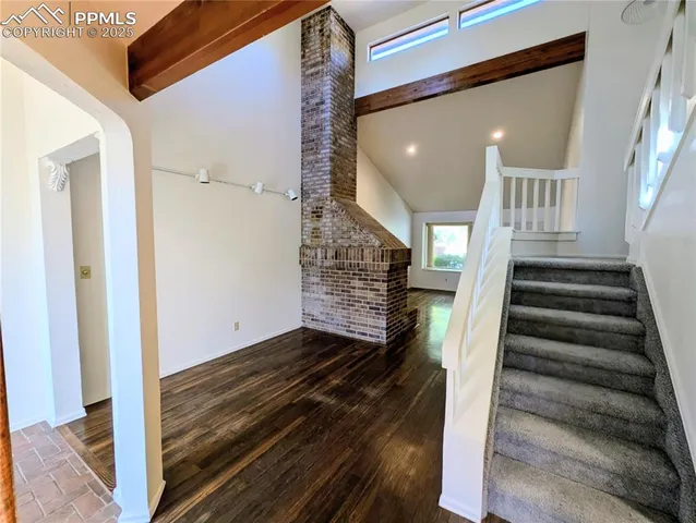 a view of an entryway with wooden floor