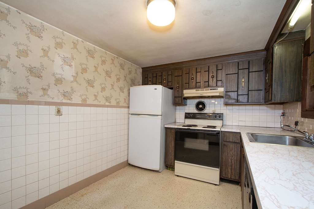 11 Raleigh Road Weymouth, MA 02189 - Photo 8 of 16 a kitchen with a sink a stove and refrigerator