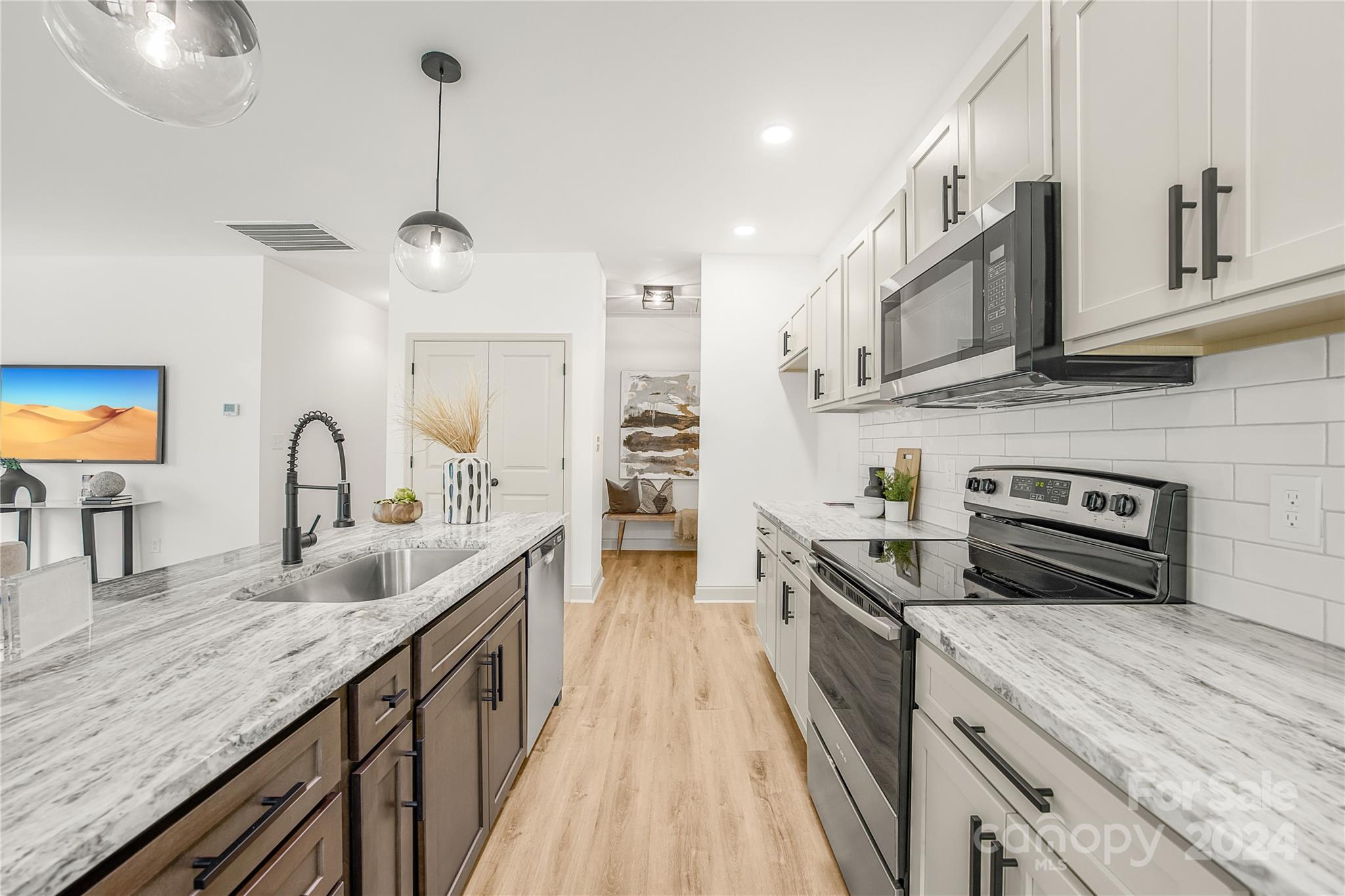 1237 Oak Hill Road Chester, SC 29706 - Photo 12 of 27 a kitchen with stainless steel appliances granite countertop a sink a stove and a wooden floors