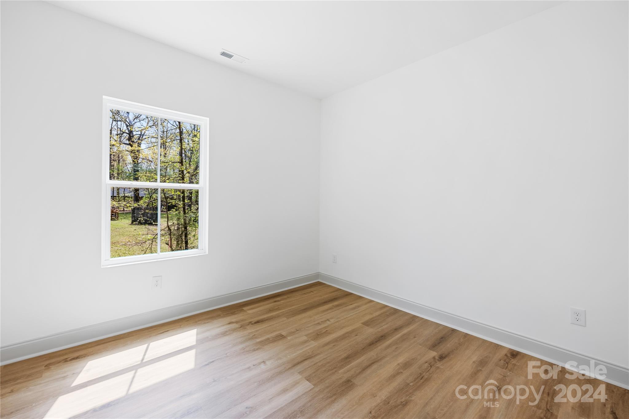 1237 Oak Hill Road Chester, SC 29706 - Photo 21 of 27 an empty room with wooden floor and windows