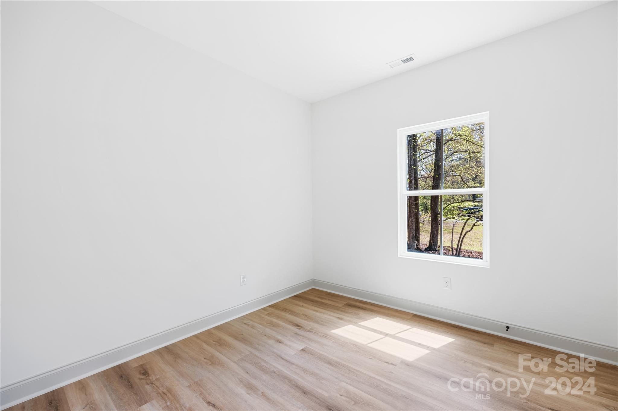 1237 Oak Hill Road Chester, SC 29706 - Photo 22 of 27 an empty room with wooden floor and windows