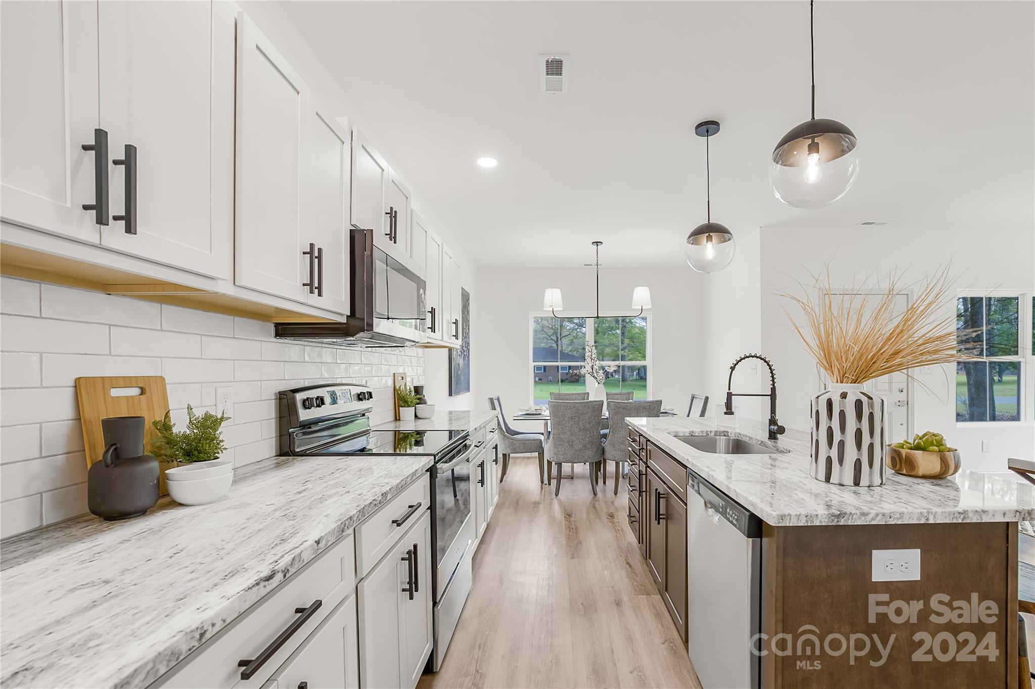 1237 Oak Hill Road Chester, SC 29706 - Photo 8 of 27 a kitchen with stainless steel appliances granite countertop a sink a stove and a wooden floors