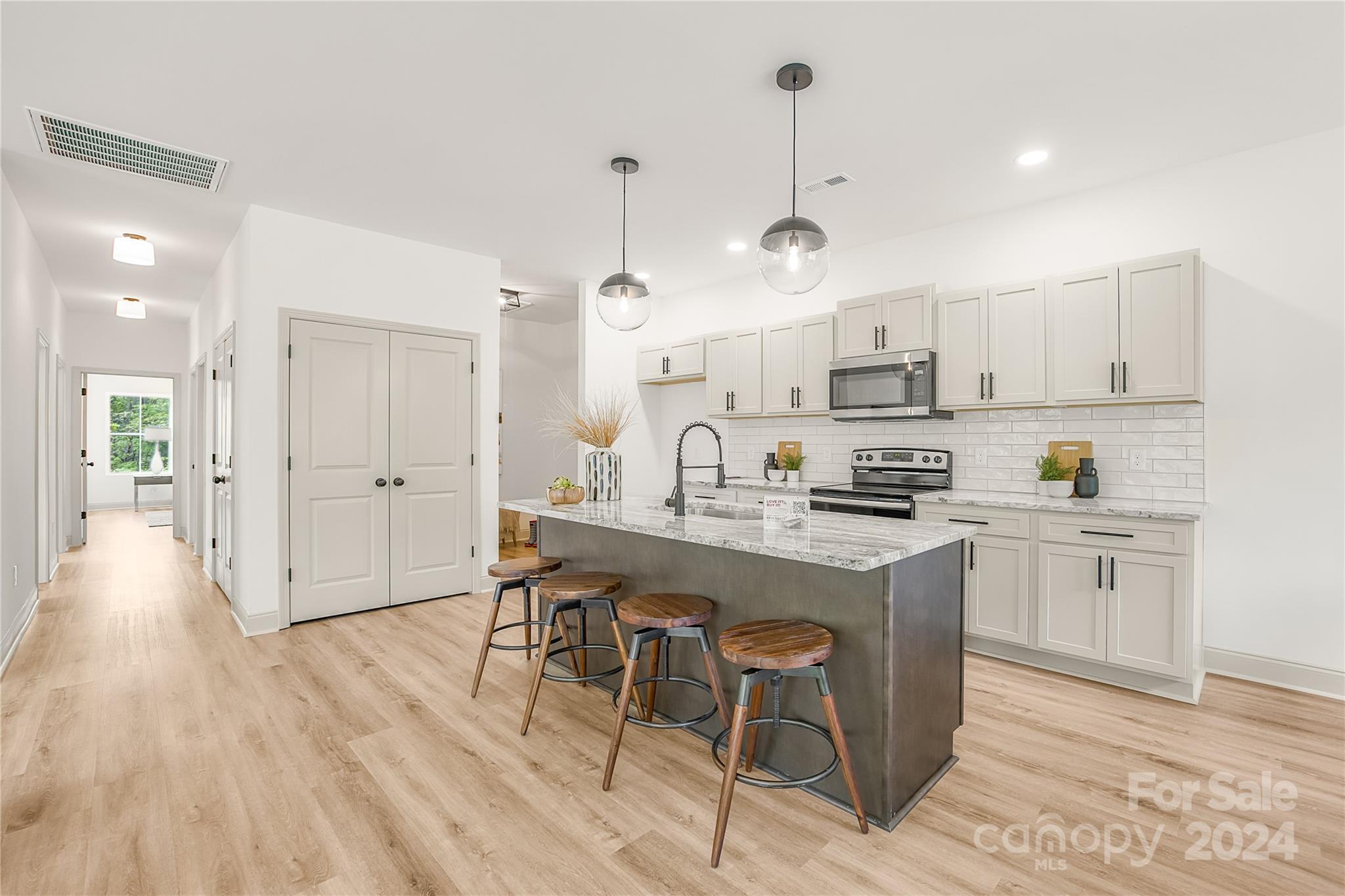 1237 Oak Hill Road Chester, SC 29706 - Photo 10 of 27 a kitchen with kitchen island granite countertop a sink cabinets and wooden floor