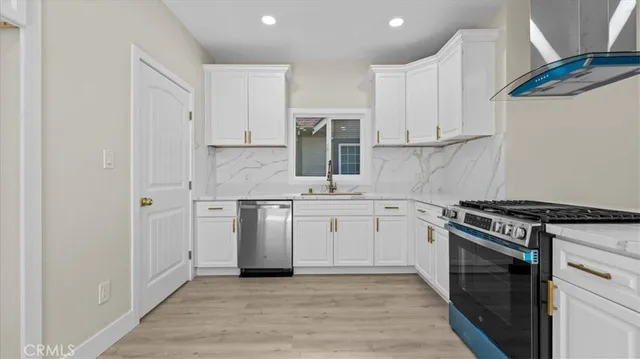 a kitchen with white cabinets and appliances