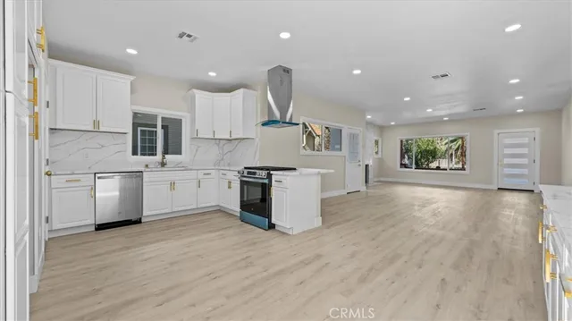 a kitchen with a sink stainless steel appliances and cabinets