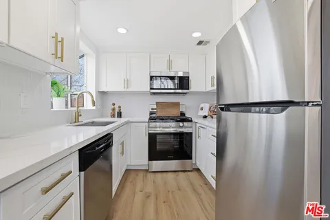 a kitchen with a refrigerator a sink and a stove