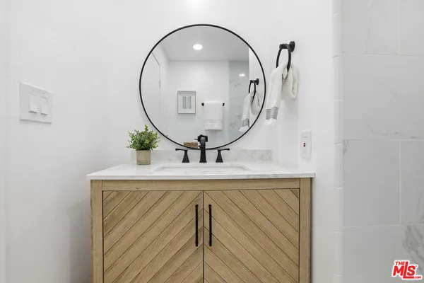 a bathroom with a sink mirror and vanity