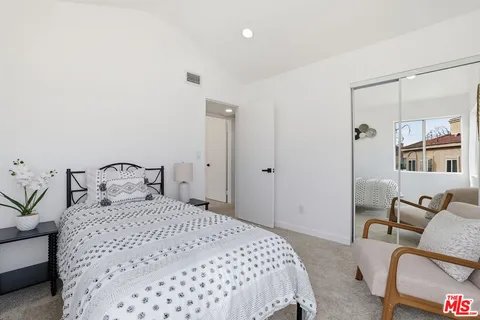 a bedroom with a bed and a couch