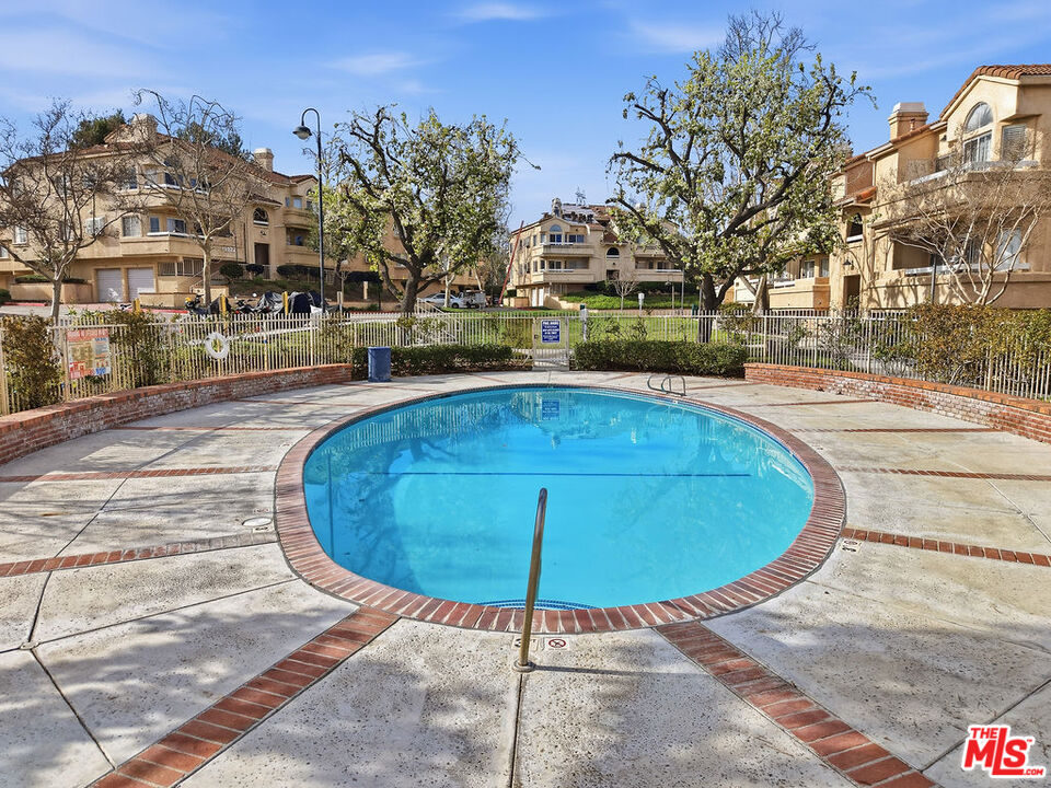 19834 Sandpiper Place, Unit 64 Newhall, CA 91321 - Photo 36 of 40 a view of a swimming pool with a patio