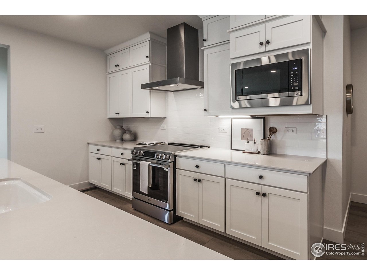 792 Chatter Road Windsor, CO 80550 - Photo 15 of 42 a kitchen with stainless steel appliances a stove a sink and a microwave