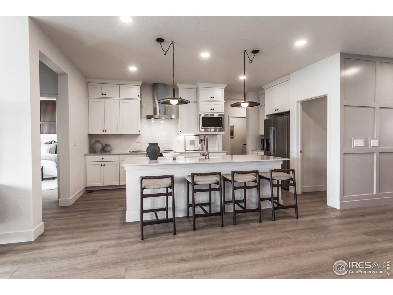 792 Chatter Road Windsor, CO 80550 - Photo 16 of 42 a open kitchen with kitchen island granite countertop a sink and a refrigerator
