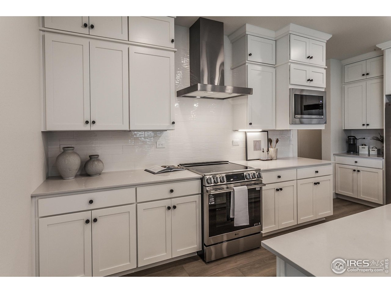 792 Chatter Road Windsor, CO 80550 - Photo 17 of 42 a kitchen with stainless steel appliances granite countertop a sink a stove and cabinets