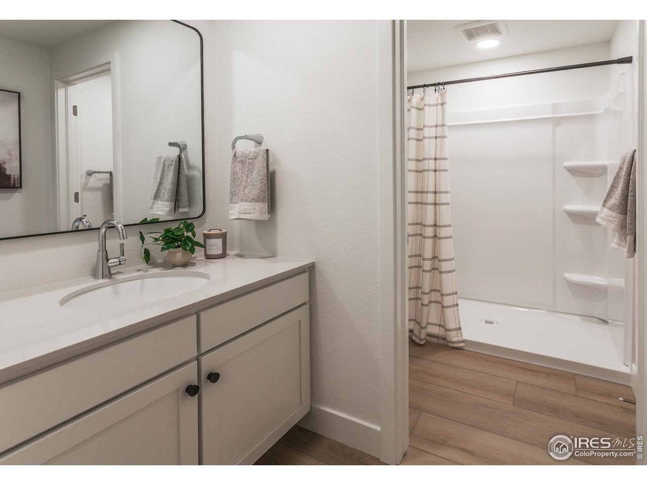 792 Chatter Road Windsor, CO 80550 - Photo 34 of 42 a bathroom with a sink and a mirror